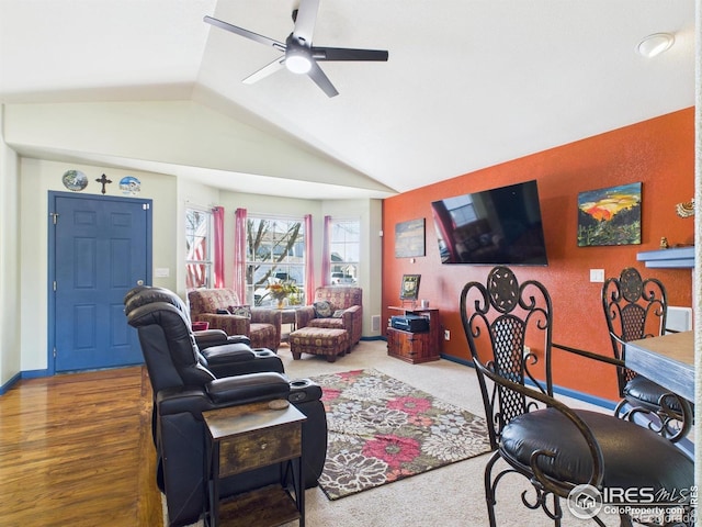 living room with baseboards, a ceiling fan, and vaulted ceiling