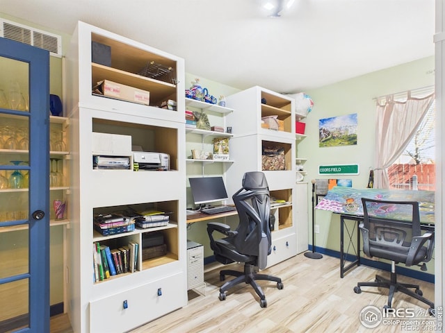 office area with visible vents and wood finished floors