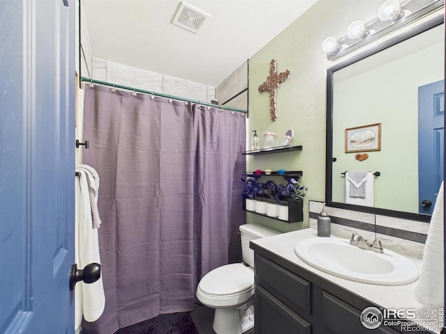 full bathroom featuring toilet, vanity, visible vents, and a shower with curtain