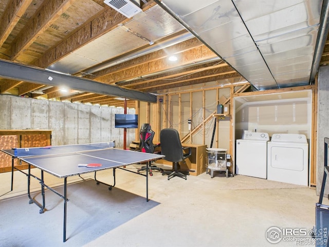 recreation room featuring concrete flooring, visible vents, and washer and clothes dryer