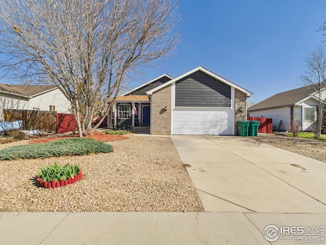 single story home featuring brick siding, driveway, fence, and a garage
