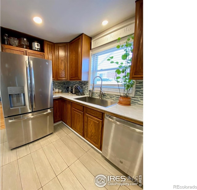 7170 Zuni St, Denver, CO 80221 - kitchen featuring light countertops, tasteful backsplash, a sink, and stainless steel appliances