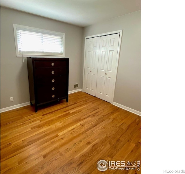 7170 Zuni St, Denver, CO 80221 - unfurnished bedroom featuring visible vents, baseboards, and light wood-type flooring