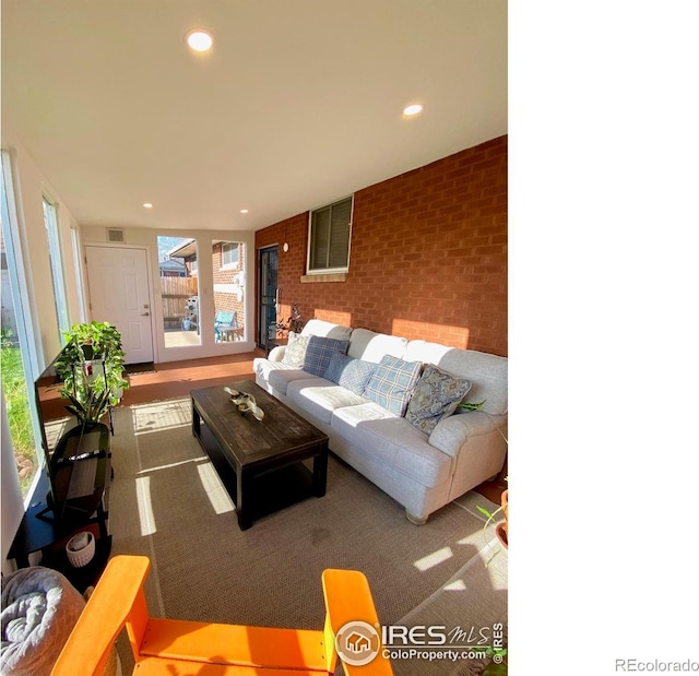 7170 Zuni St, Denver, CO 80221 - living area with visible vents, recessed lighting, and brick wall
