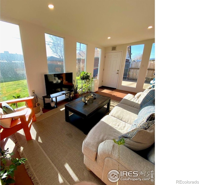 7170 Zuni St, Denver, CO 80221 - living room featuring visible vents, recessed lighting, plenty of natural light, and wood finished floors