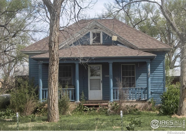 bungalow featuring roof with shingles and a porch