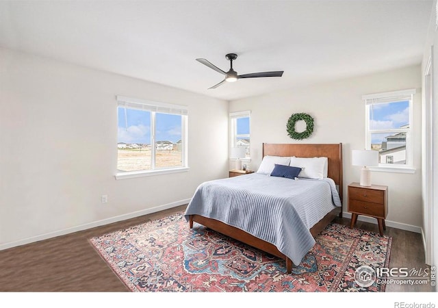 bedroom with ceiling fan, baseboards, and wood finished floors