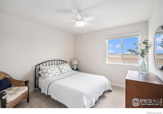 carpeted bedroom with baseboards and a ceiling fan