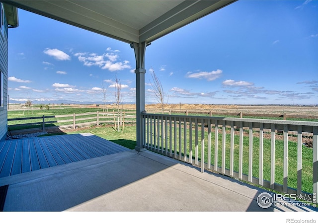 view of patio / terrace with a rural view and fence