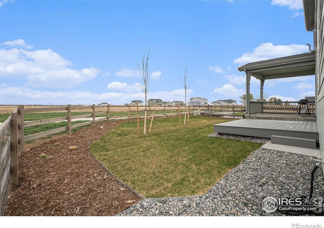 view of yard with fence and a wooden deck