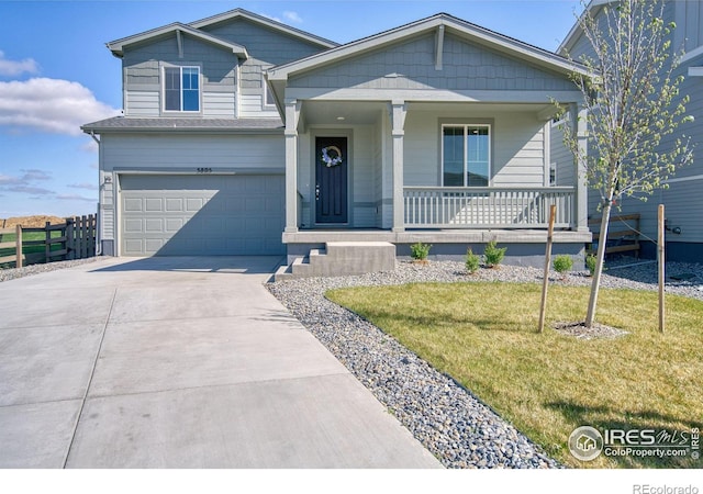 view of front of home with driveway, fence, an attached garage, a porch, and a front lawn