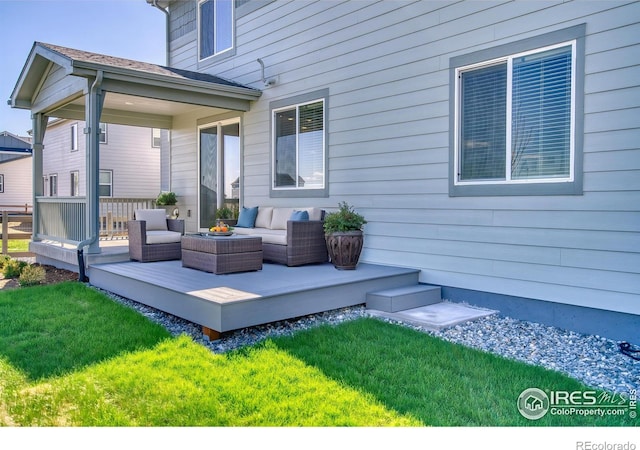 exterior space with an outdoor hangout area, a lawn, and a wooden deck
