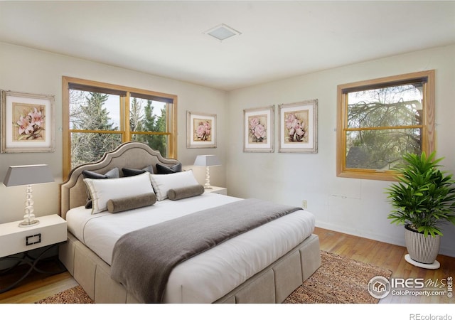1780 Redwood Ave, Boulder, CO 80304 - bedroom with multiple windows and light wood-type flooring