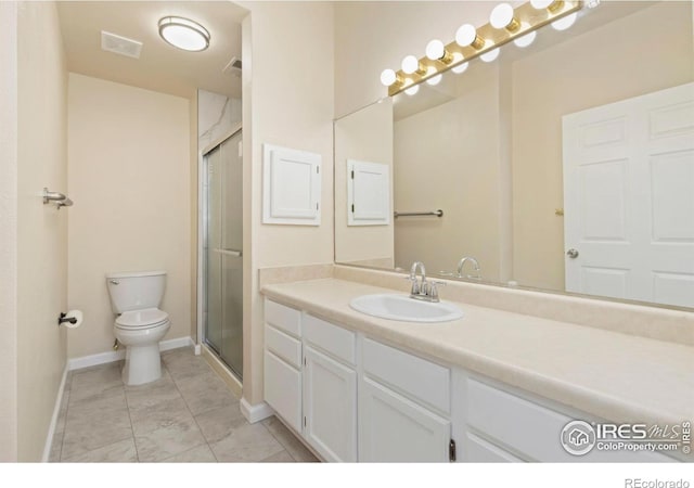 bathroom with a shower with door, vanity, baseboards, toilet, and visible vents