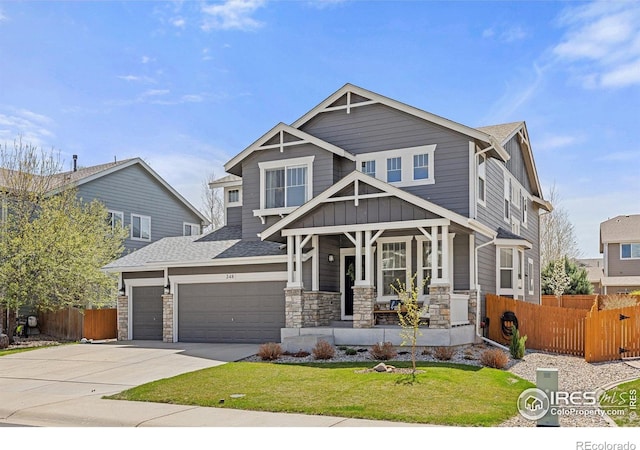 248 Muscovey Ln, Johnstown, CO 80534 - craftsman inspired home with a porch, fence, stone siding, and concrete driveway