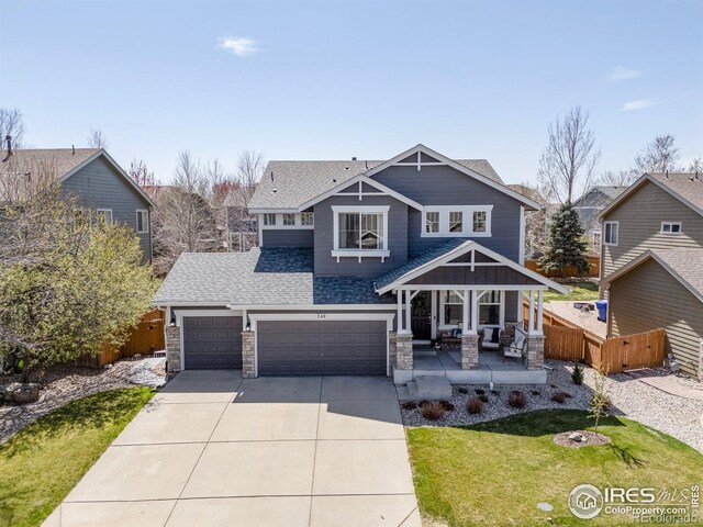 248 Muscovey Ln, Johnstown, CO 80534 - craftsman-style house with a shingled roof, driveway, fence, and stone siding