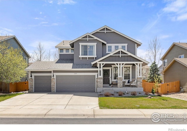 248 Muscovey Ln, Johnstown, CO 80534 - craftsman-style house with roof with shingles, driveway, stone siding, fence, and covered porch