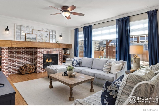 248 Muscovey Ln, Johnstown, CO 80534 - living area with wood finished floors, ceiling fan, and a fireplace