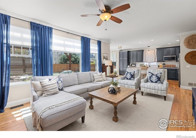 248 Muscovey Ln, Johnstown, CO 80534 - living area with visible vents, a ceiling fan, light wood-style floors, and a healthy amount of sunlight