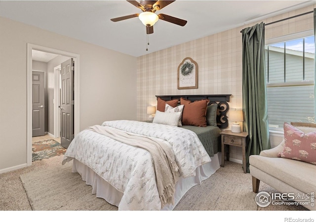 248 Muscovey Ln, Johnstown, CO 80534 - carpeted bedroom with ceiling fan, wallpapered walls, an accent wall, and baseboards