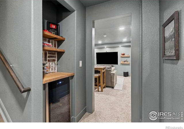 248 Muscovey Ln, Johnstown, CO 80534 - hall featuring wine cooler, carpet floors, and a textured wall