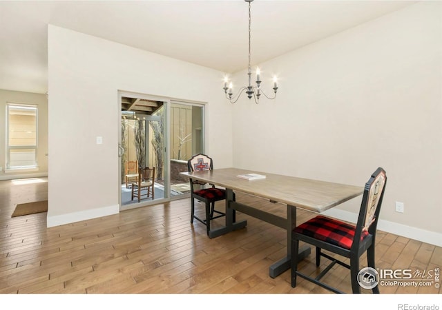 1658 Freewheel Dr, Fort Collins, CO 80525 - dining space featuring baseboards, light wood-type flooring, and a chandelier