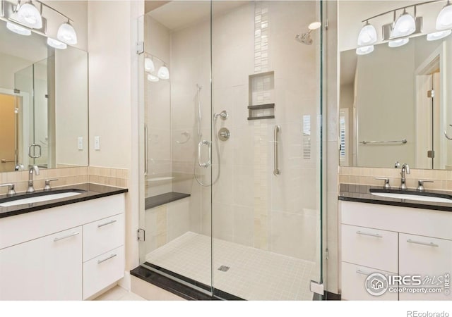 1658 Freewheel Dr, Fort Collins, CO 80525 - bathroom featuring a sink, backsplash, two vanities, and a stall shower