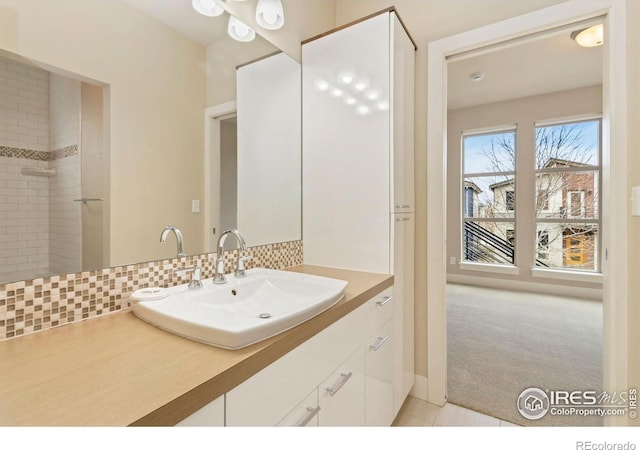 1658 Freewheel Dr, Fort Collins, CO 80525 - bathroom featuring tile patterned flooring, vanity, and backsplash