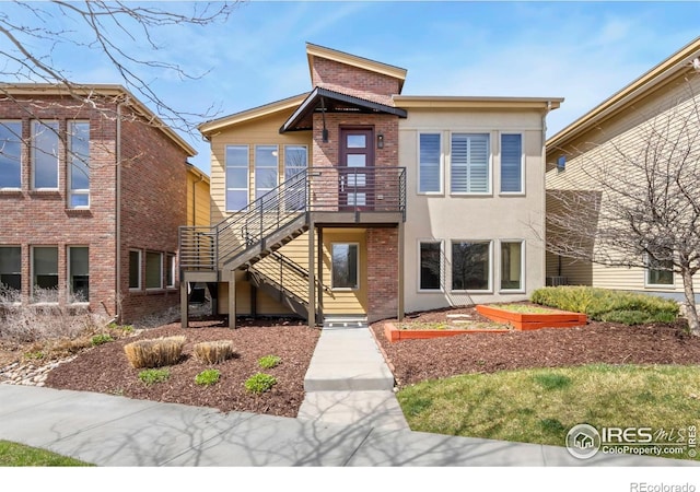 1658 Freewheel Dr, Fort Collins, CO 80525 - contemporary home featuring a garden, stairs, stucco siding, and brick siding