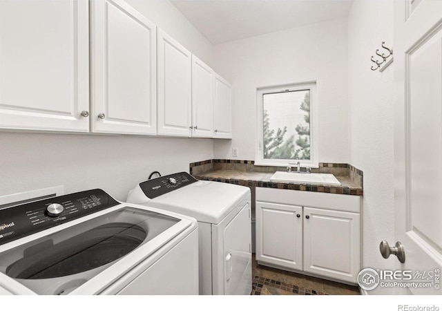 laundry area featuring a sink, cabinet space, and washer and clothes dryer