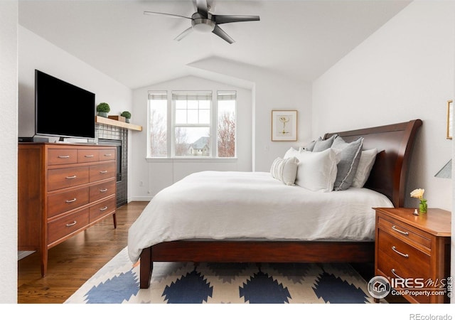 bedroom with dark wood-style flooring, baseboards, vaulted ceiling, and a ceiling fan