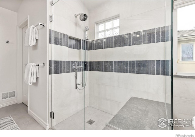 bathroom with visible vents, baseboards, and a shower stall