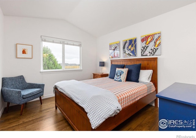 bedroom with wood finished floors, baseboards, and lofted ceiling