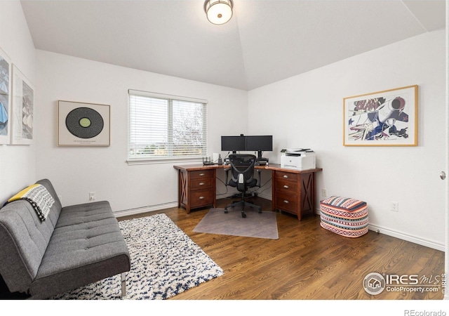 home office featuring baseboards, vaulted ceiling, and wood finished floors