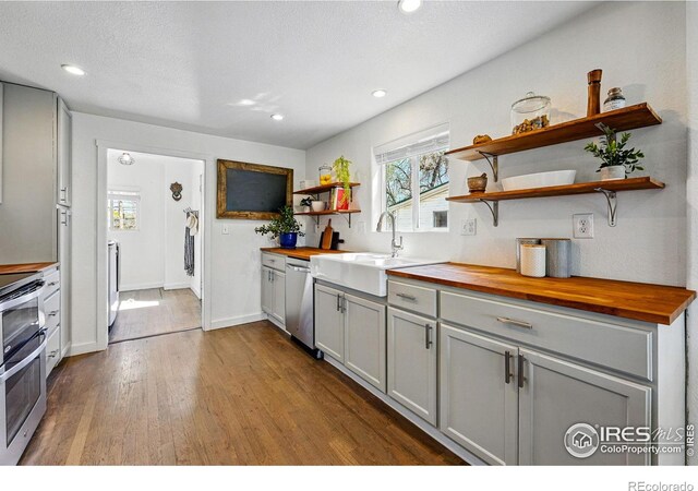 285 Holbrook St, Erie, CO 80516 - kitchen featuring butcher block counters, appliances with stainless steel finishes, gray cabinetry, and open shelves