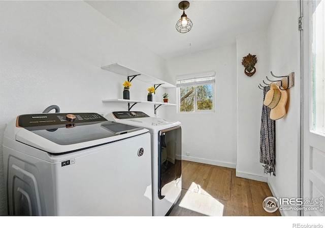 285 Holbrook St, Erie, CO 80516 - clothes washing area featuring laundry area, washing machine and clothes dryer, baseboards, and light wood-style floors