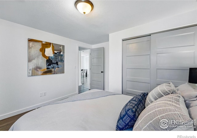 285 Holbrook St, Erie, CO 80516 - bedroom with a closet, baseboards, and dark wood-style floors
