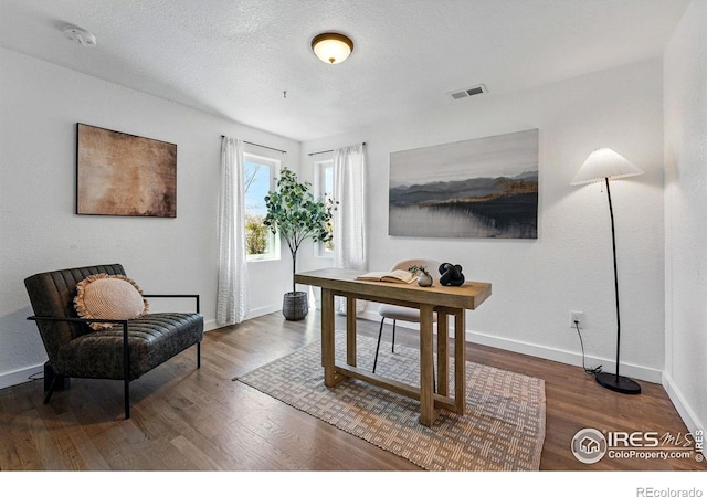 285 Holbrook St, Erie, CO 80516 - home office with visible vents, baseboards, and wood finished floors