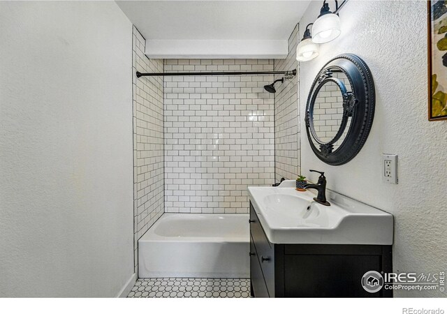 285 Holbrook St, Erie, CO 80516 - bathroom featuring a textured wall, washtub / shower combination, vanity, and baseboards