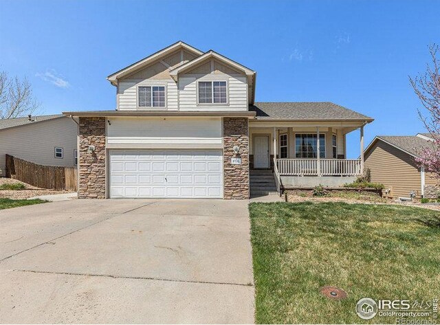 8715 18th Street Rd, Greeley, CO 80634 - traditional-style house with a porch, a front yard, fence, stone siding, and concrete driveway