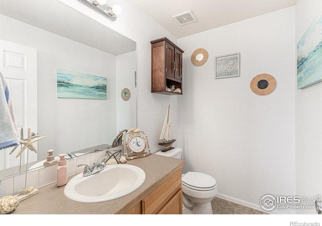 8715 18th Street Rd, Greeley, CO 80634 - half bathroom with vanity, visible vents, and toilet