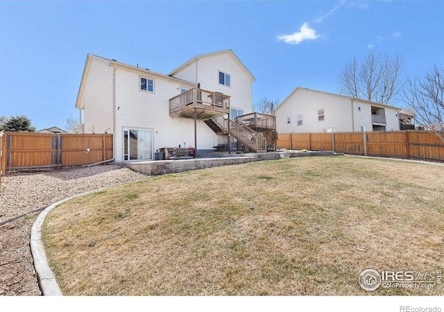 8715 18th Street Rd, Greeley, CO 80634 - back of property featuring a fenced backyard, stairway, a wooden deck, and a lawn