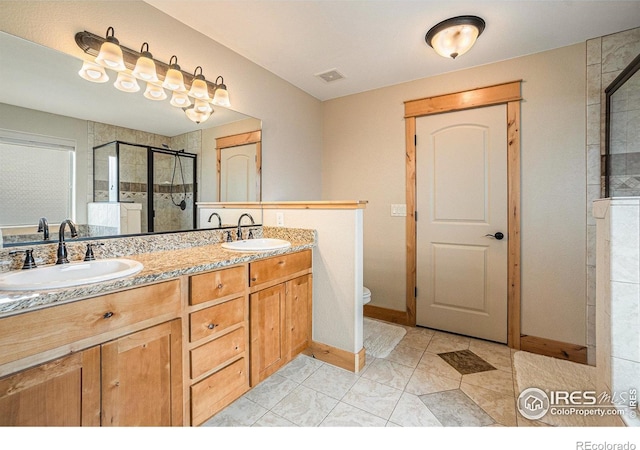 full bathroom with a stall shower, double vanity, a sink, and visible vents