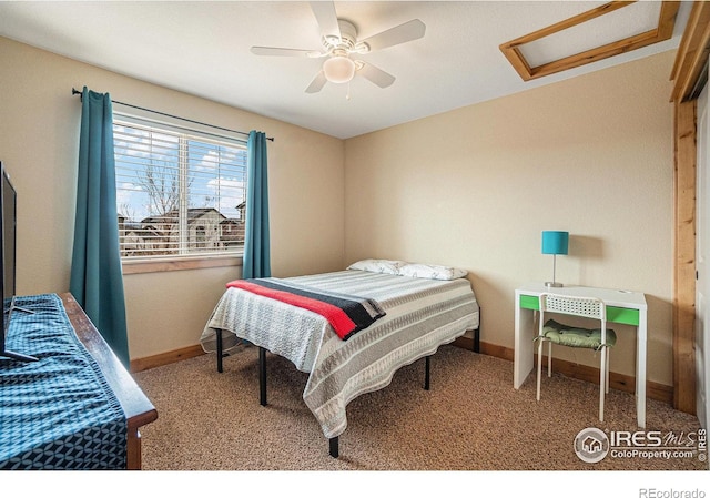 carpeted bedroom featuring ceiling fan, attic access, and baseboards