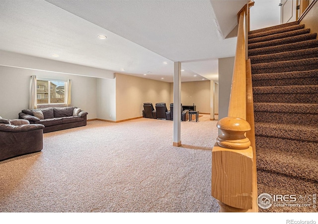 carpeted living area with recessed lighting, baseboards, and stairway