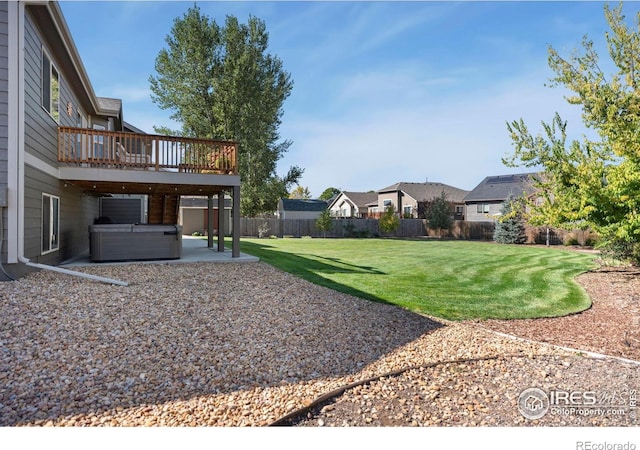 view of yard featuring a residential view, a patio, fence, and a hot tub