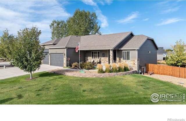 ranch-style house featuring a garage, stone siding, fence, a front lawn, and driveway