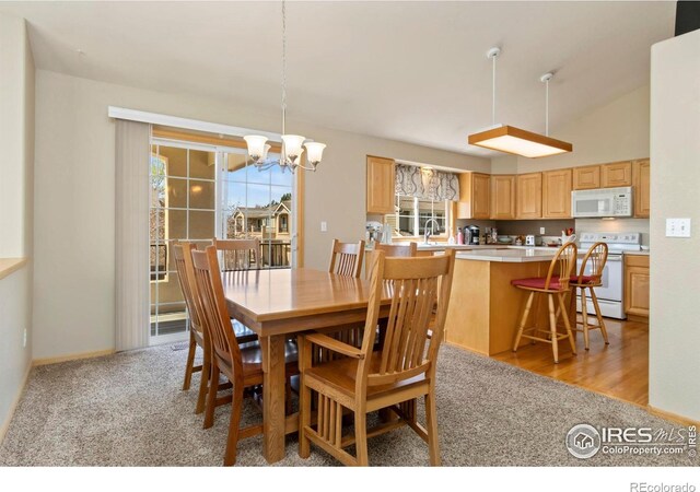 5151 Boardwalk Dr Unit K4, Fort Collins, CO 80525 - dining area with a chandelier and light colored carpet