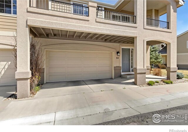 5151 Boardwalk Dr Unit K4, Fort Collins, CO 80525 - view of front of property featuring a garage, driveway, and stucco siding