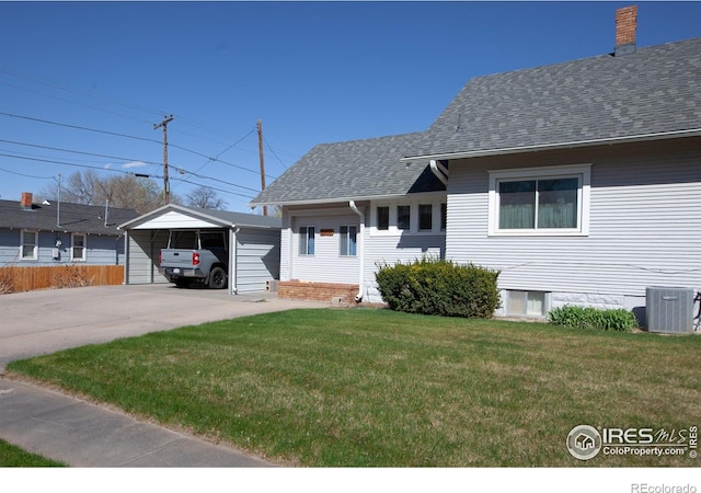230 Beattie St, Sterling, CO 80751 - view of front of home with a carport, a front lawn, central AC, fence, and a shingled roof